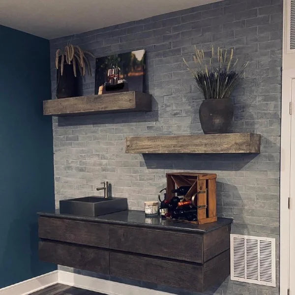 Modern wall shelf with decor items including plants, photos, and vases