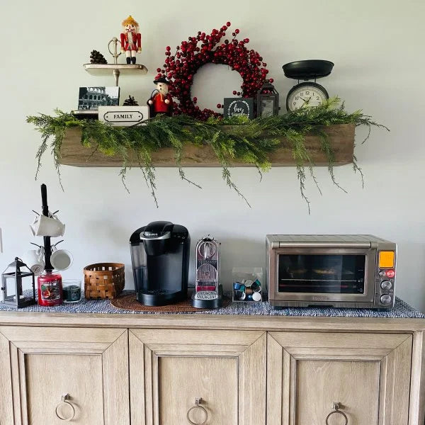 Modern wall shelf with decor items including plants, photos, and vases