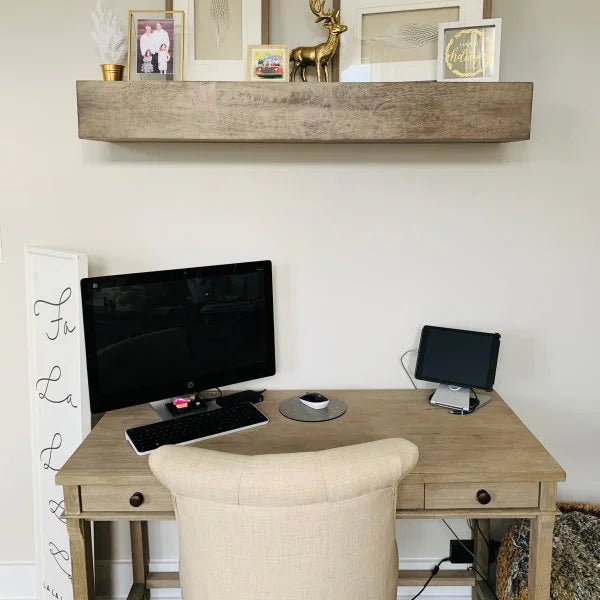 Modern wall shelf with decor items including plants, photos, and vases