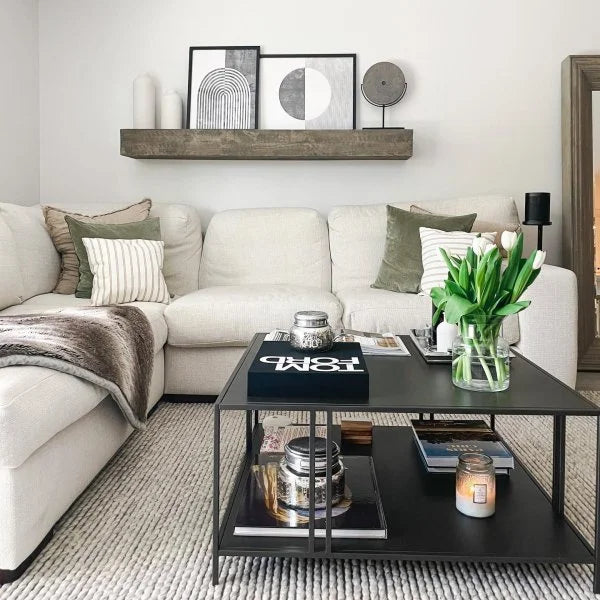 Modern wall shelf with decor items including plants, photos, and vases