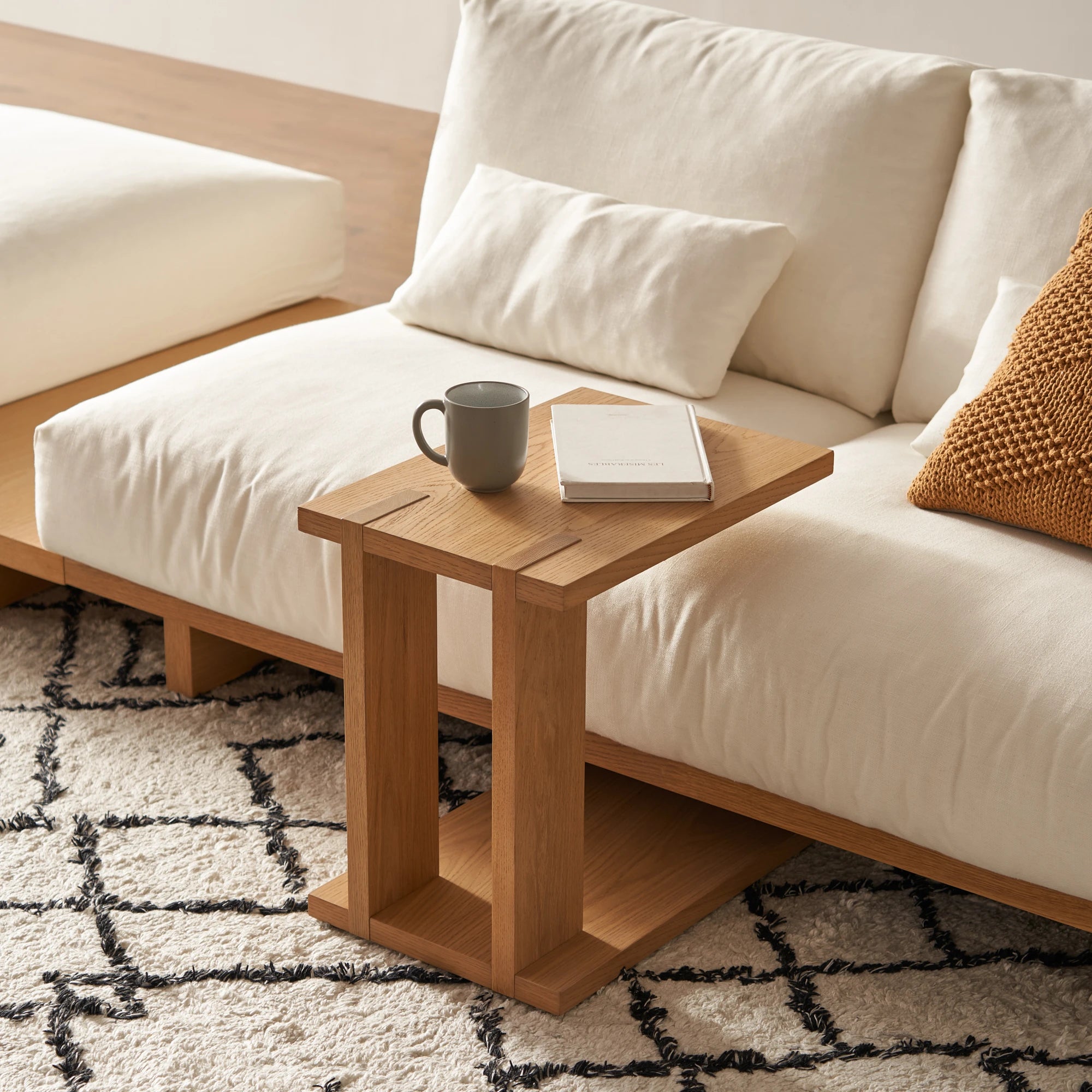 Elegant C shaped side table with open base and compact design perfect for small spaces