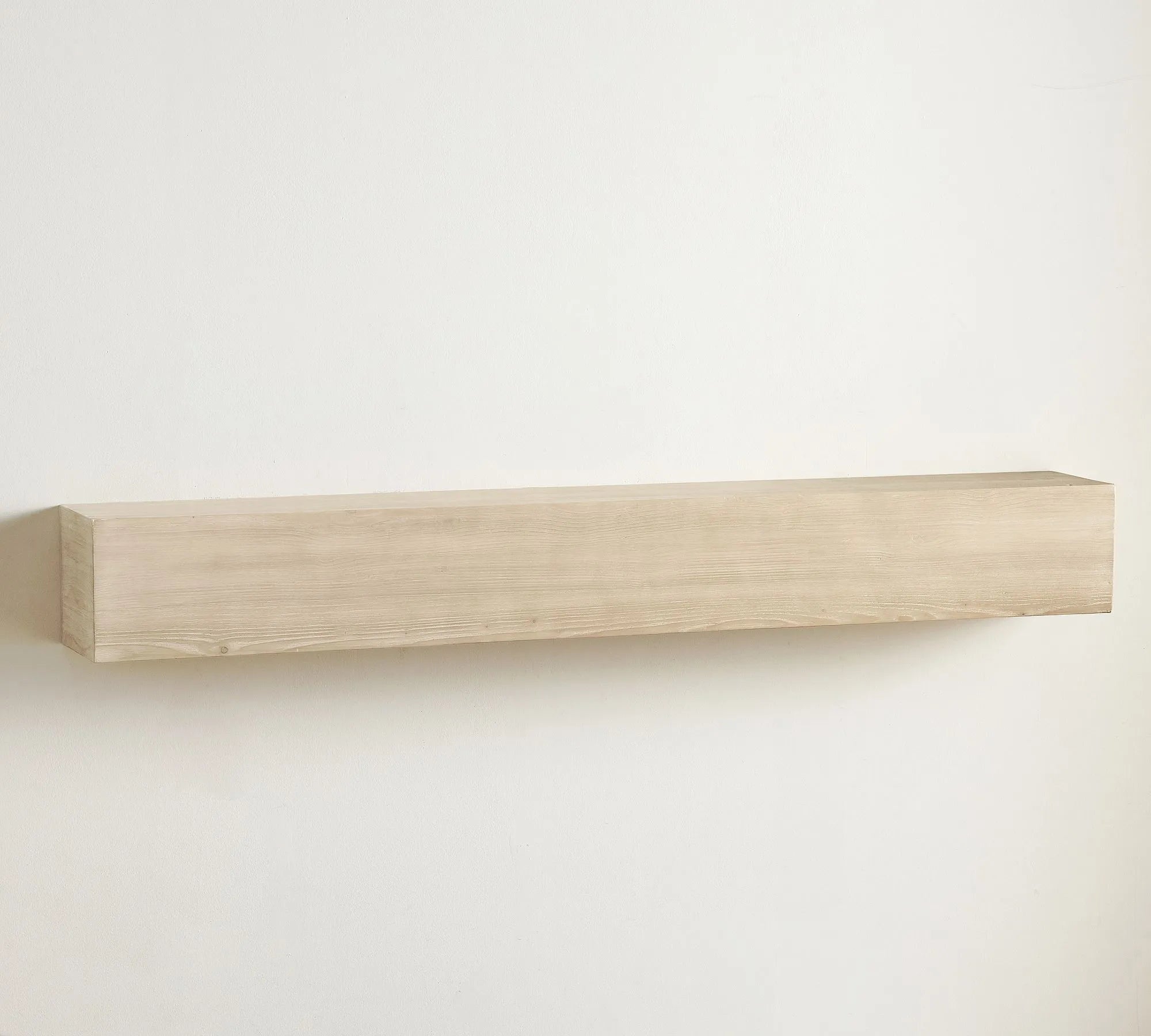 Elegant wall shelf decorated with framed art, candles, and sculptures