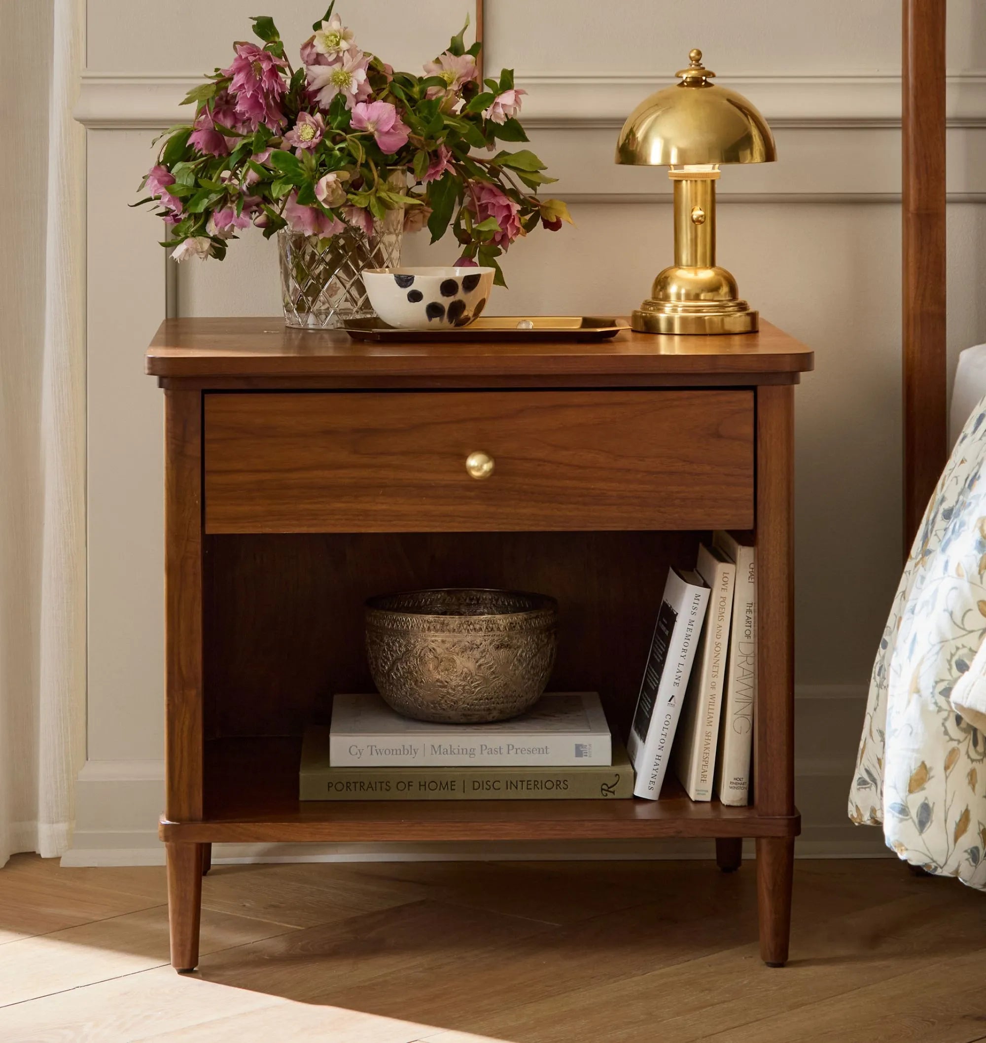 Mid century nightstand with open shelf, single drawer, and brass knob.