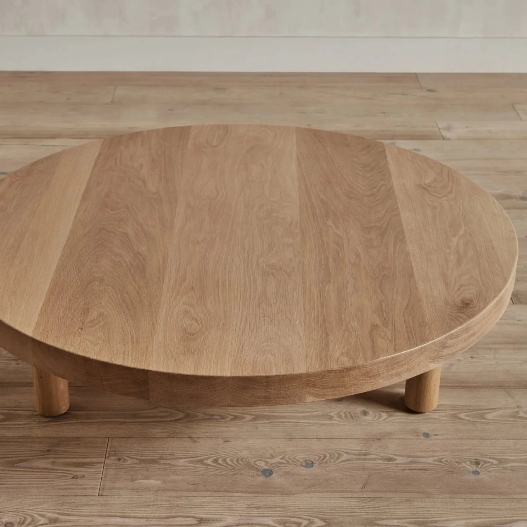 Round Low Profile Coffee Table with cylindrical legs and spacious tabletop