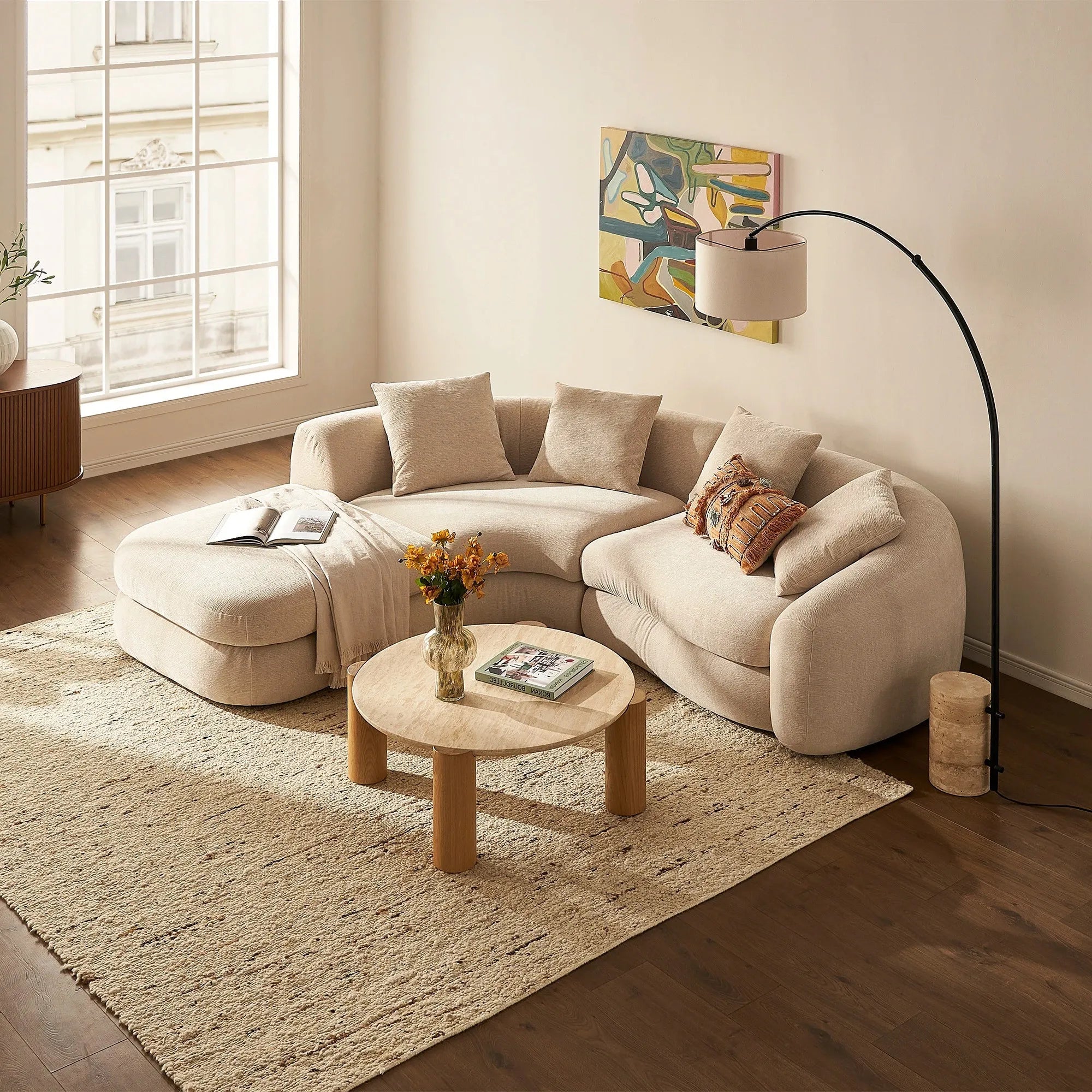 Round modern coffee table with cylindrical legs and sleek design