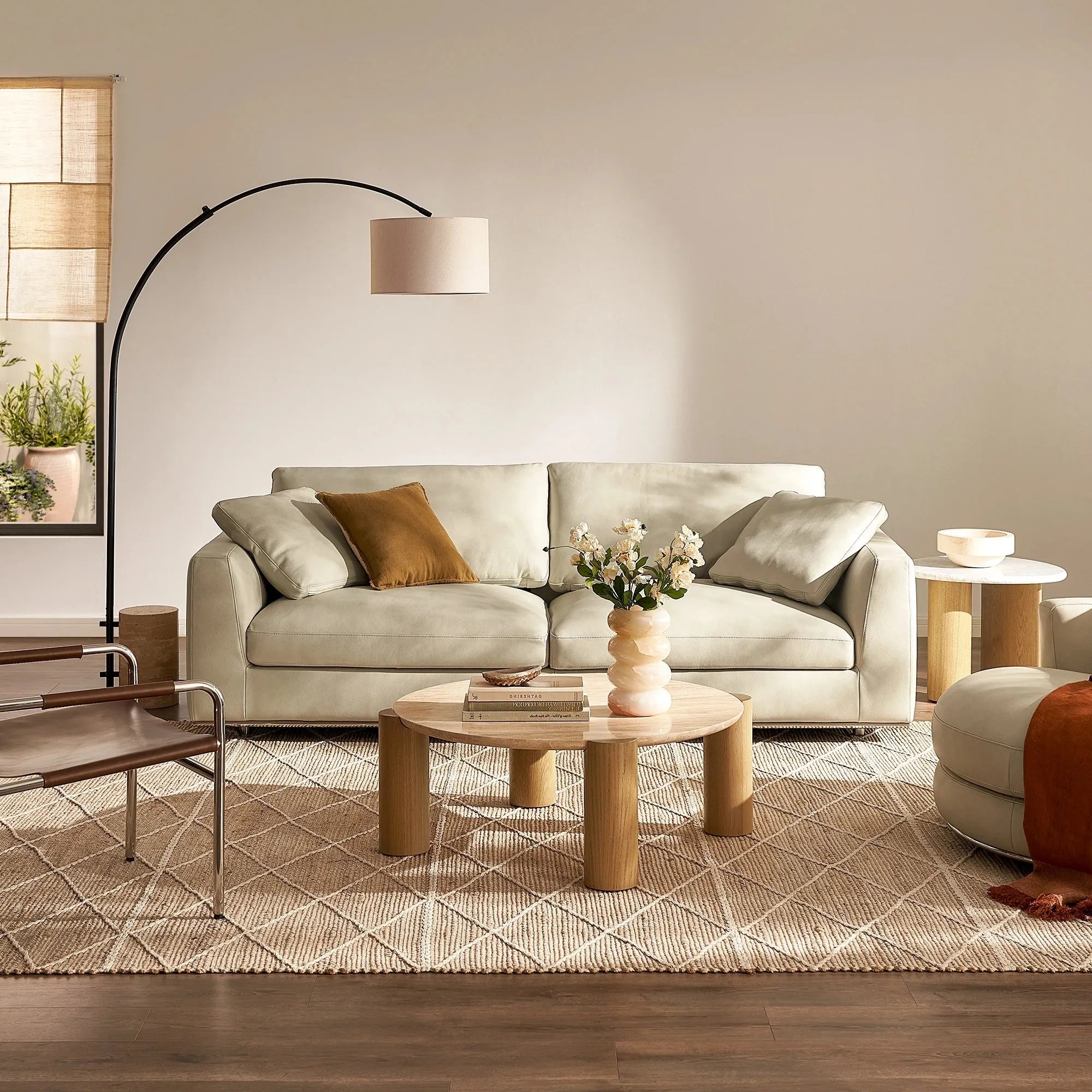 Round modern coffee table with cylindrical legs and sleek design