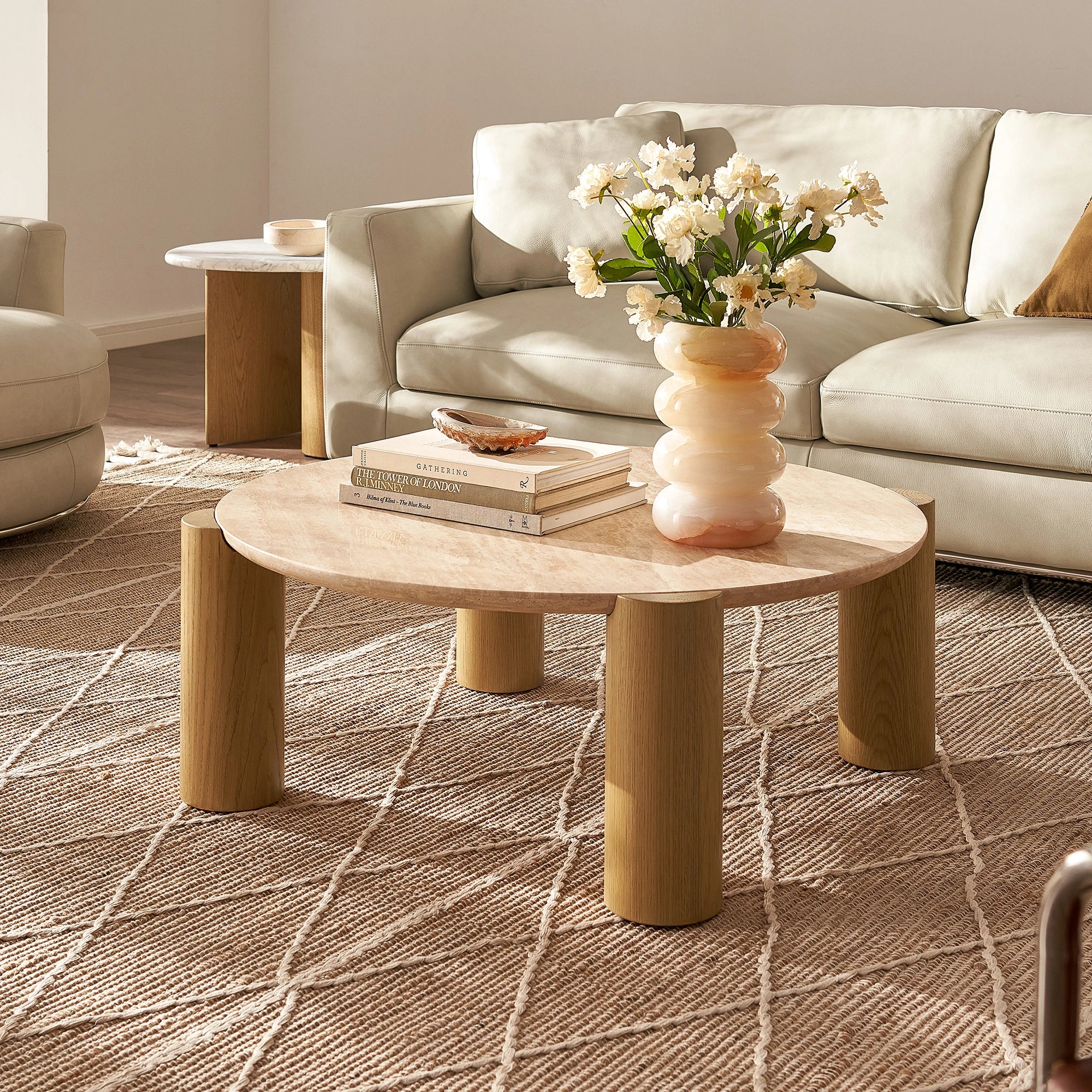 Round modern coffee table with cylindrical legs and sleek design