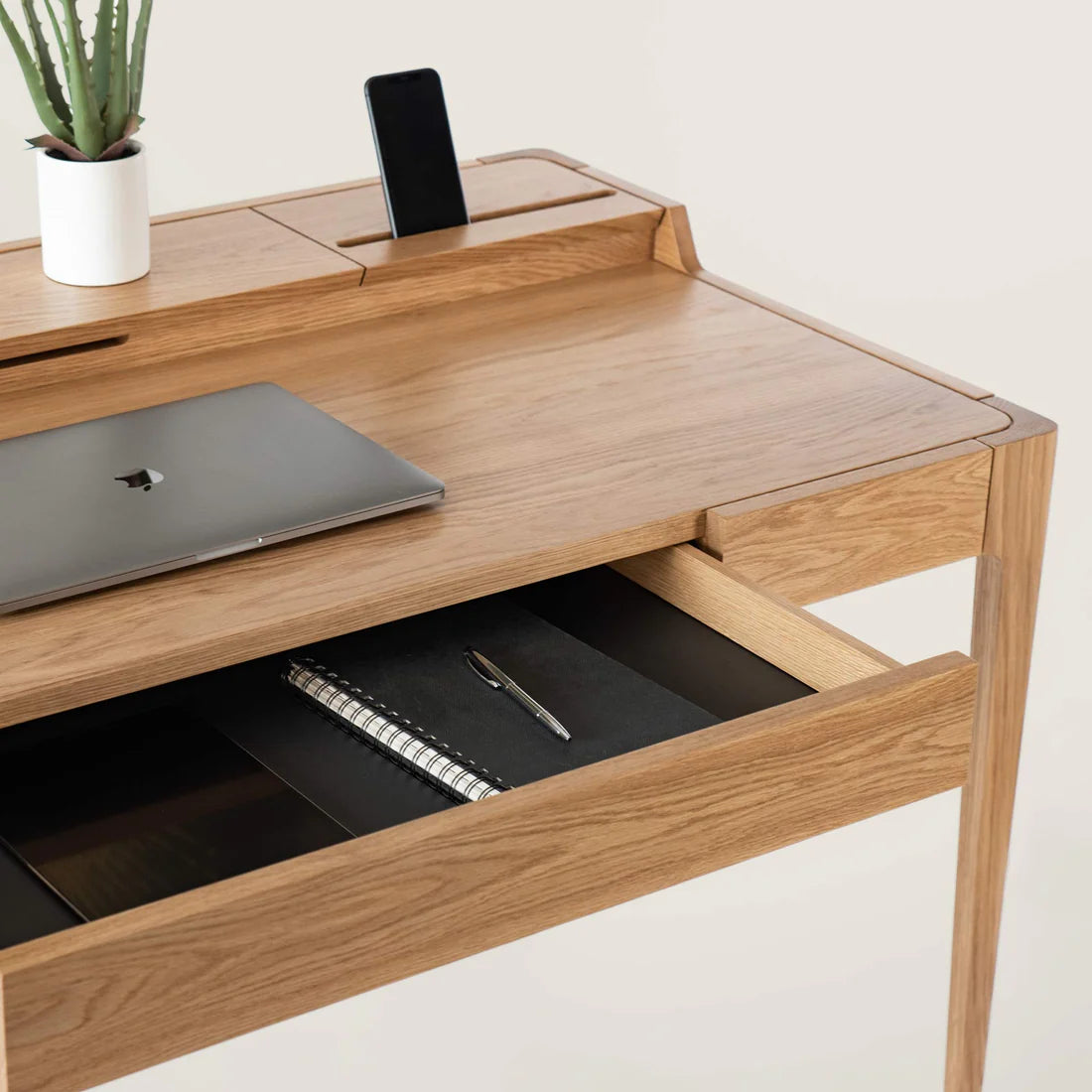 Smart Office Desk with built-in storage compartments and device slots in a modern workspace setting