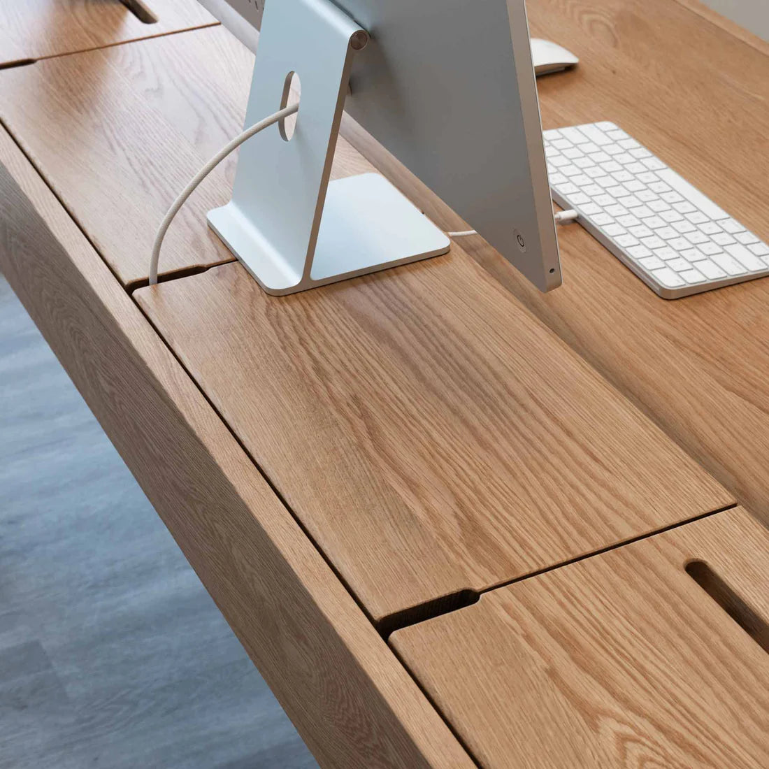 Smart Office Desk with built-in storage compartments and device slots in a modern workspace setting