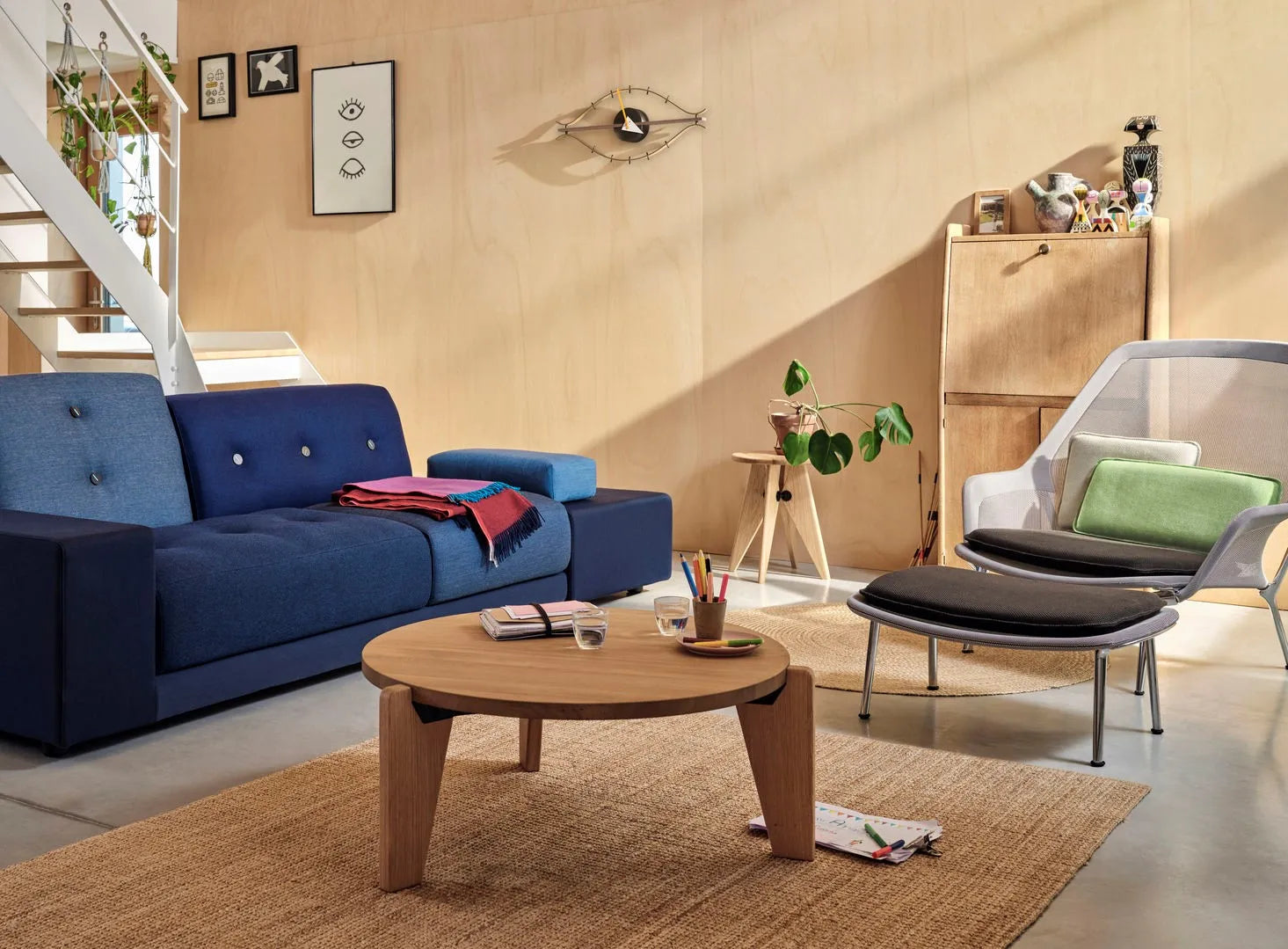 Stylish round coffee table with books and decorative flowers in a modern living room