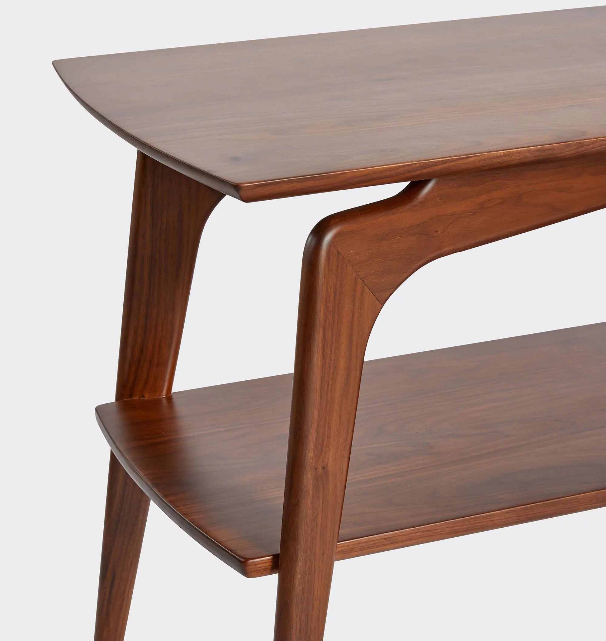 Mid century console table with curved edges, tapered legs, and two spacious shelves.