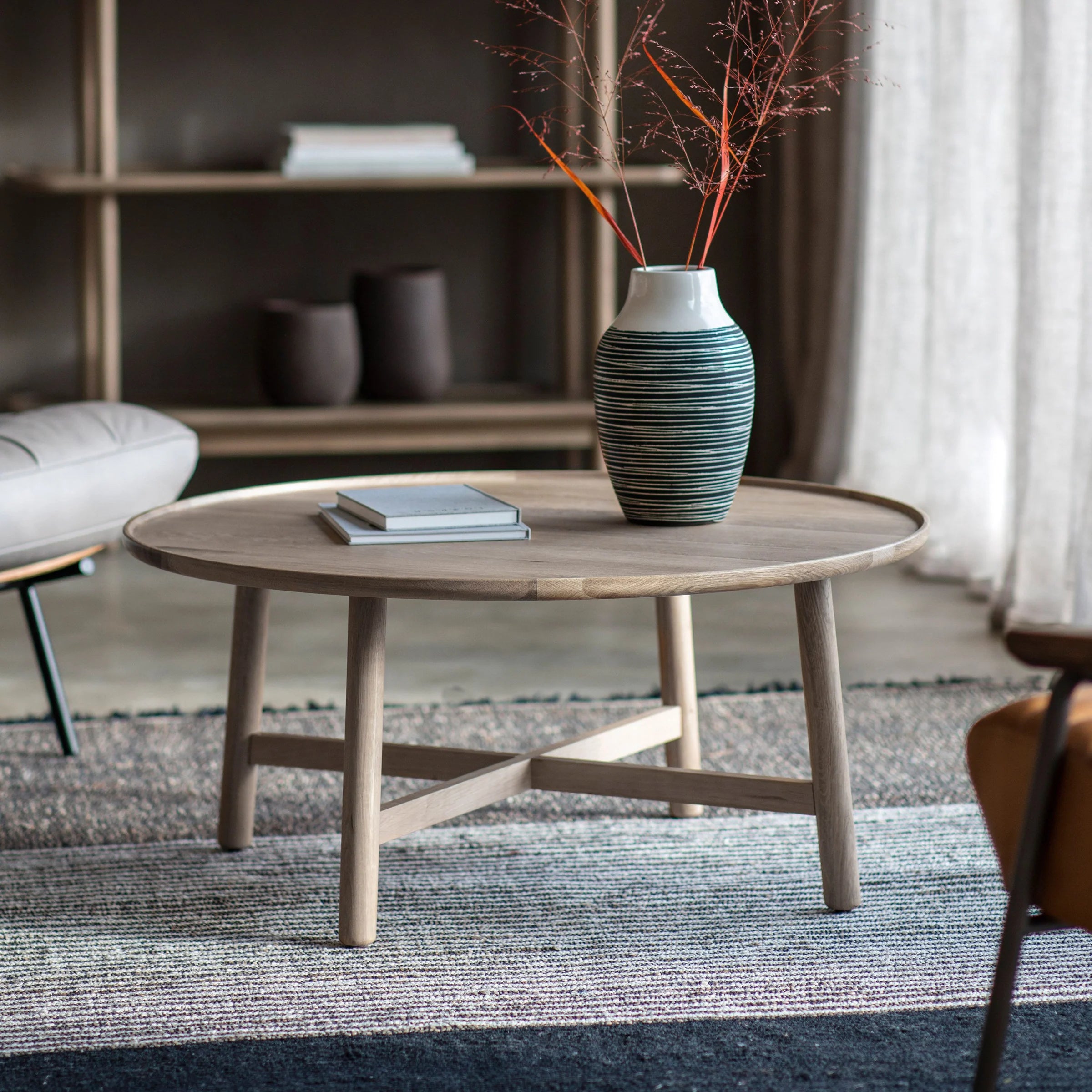 Timeless Round Coffee Table with raised edges and cross base