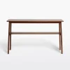 Mid century console table featuring open design, tapered legs, and dual shelves for storage.