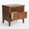 Mid century nightstand with ribbed drawer design, golden handles, and arched base.