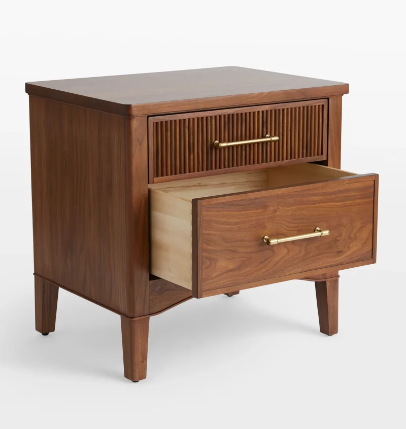 Mid century nightstand with ribbed drawer design, golden handles, and arched base.