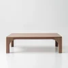 Arched leg coffee table styled in soft living room setting with sculptural presence and clean layout