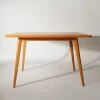 Quiet form table placed in minimal interior with angled sunlight and clean composition