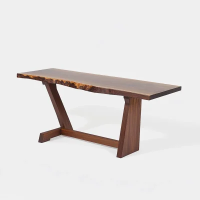 Live edge console table with angled legs styled in a sunlit modern living room